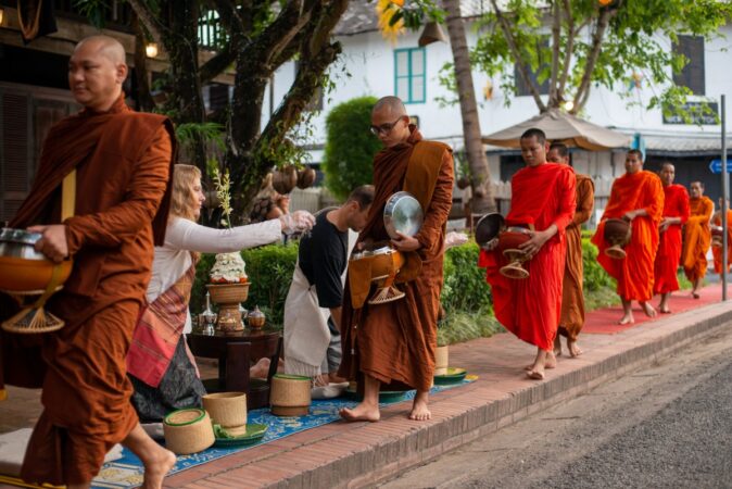 Monks go on their morning alms rounds in Luang Prabang.