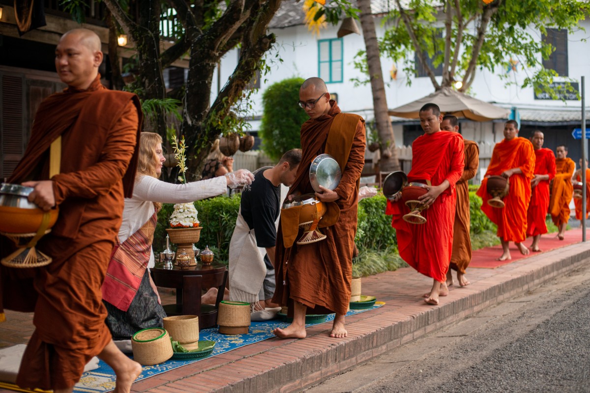 Monks go on their morning alms rounds in Luang Prabang.