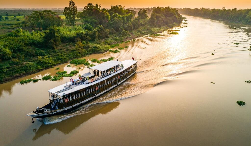 Boat on Mekong Delta river with tropical scenery