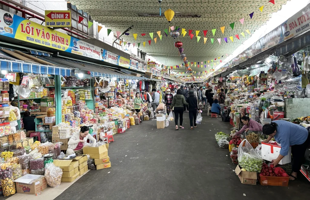 Busy local market with fresh produce and street vendors
