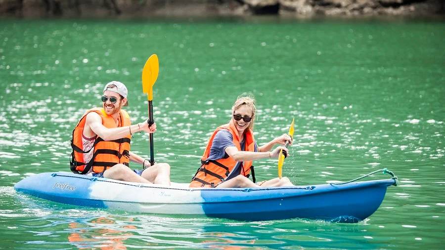 Tourists experiencing kayaking in Ha Long Bay